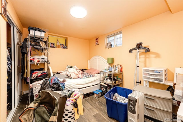 bedroom featuring hardwood / wood-style floors and a closet