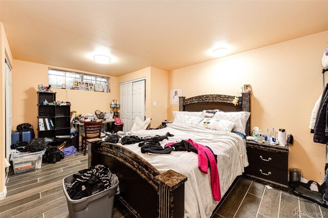 bedroom featuring dark wood-type flooring and a closet