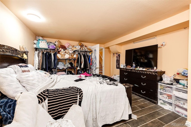 bedroom with dark wood-type flooring and a textured ceiling