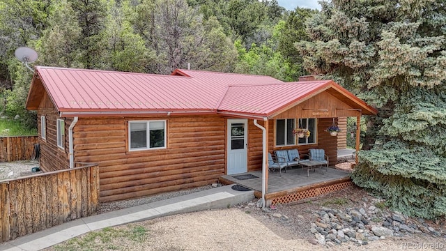 114 Loop Dr, Howard, CO 81233 - rustic home featuring metal roof, a view of trees, log veneer siding, and outdoor lounge area