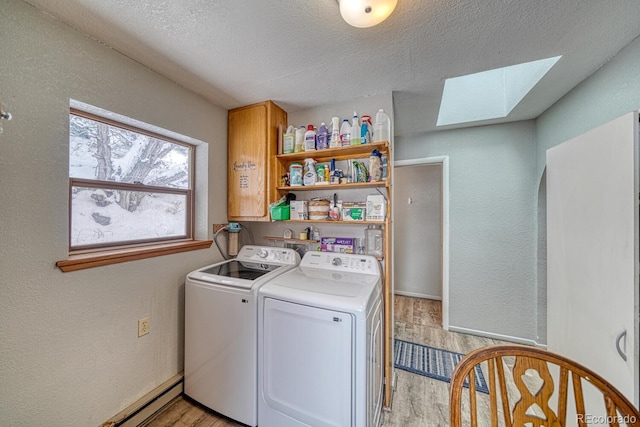 114 Loop Dr, Howard, CO 81233 - laundry area featuring a skylight, washer and dryer, light wood-type flooring, a textured ceiling, and cabinet space