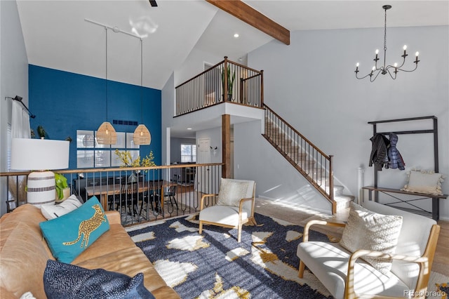 carpeted living area featuring high vaulted ceiling, beam ceiling, a notable chandelier, and stairs