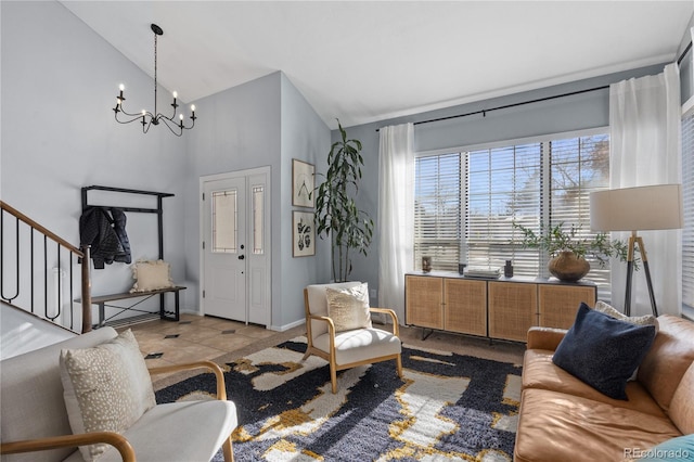 living room featuring high vaulted ceiling, stairway, an inviting chandelier, tile patterned flooring, and baseboards