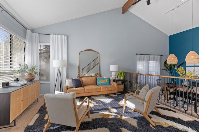 carpeted living room with beam ceiling and high vaulted ceiling