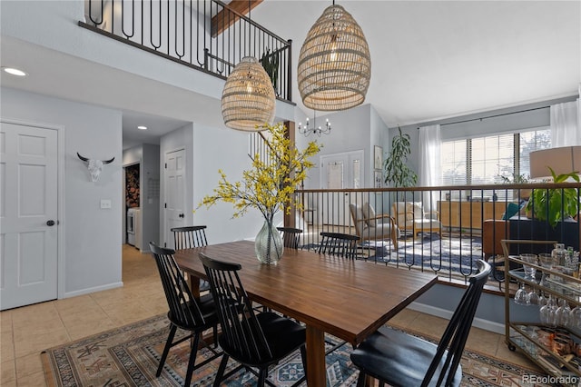 tiled dining space featuring washer / dryer, recessed lighting, baseboards, and an inviting chandelier