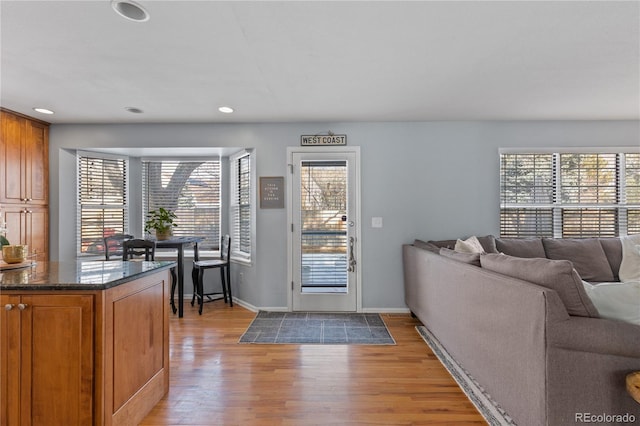 interior space featuring recessed lighting, light wood-style floors, baseboards, and a wealth of natural light