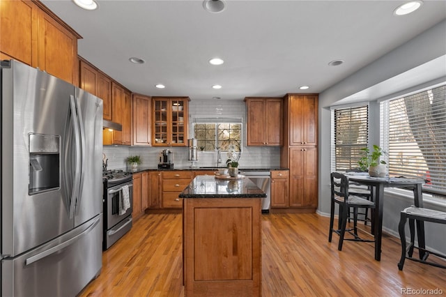 kitchen featuring a center island, brown cabinetry, and stainless steel appliances