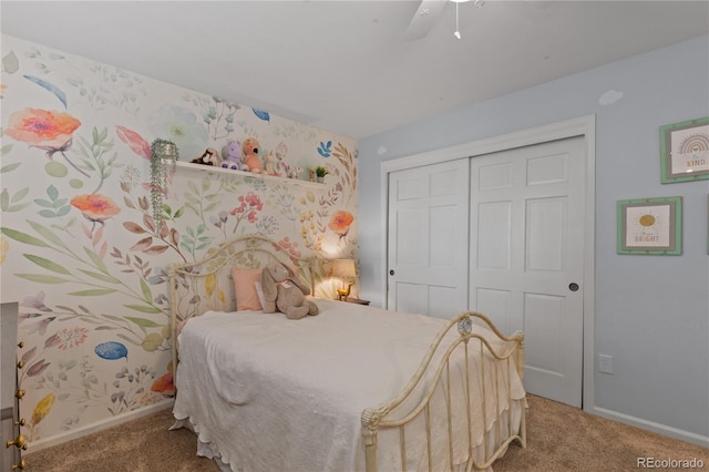 bedroom with a closet, carpet, wallpapered walls, baseboards, and ceiling fan