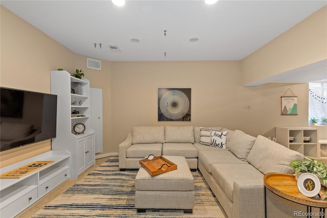 living room with visible vents and light colored carpet