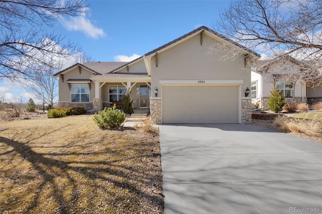 view of front of home featuring stone siding, concrete driveway, an attached garage, and stucco siding