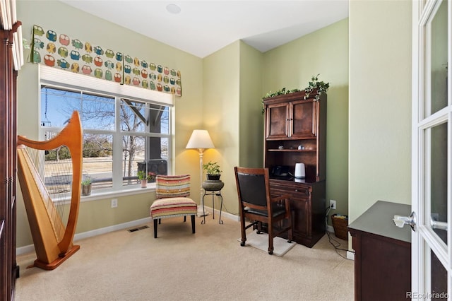 office area featuring visible vents, light carpet, and baseboards