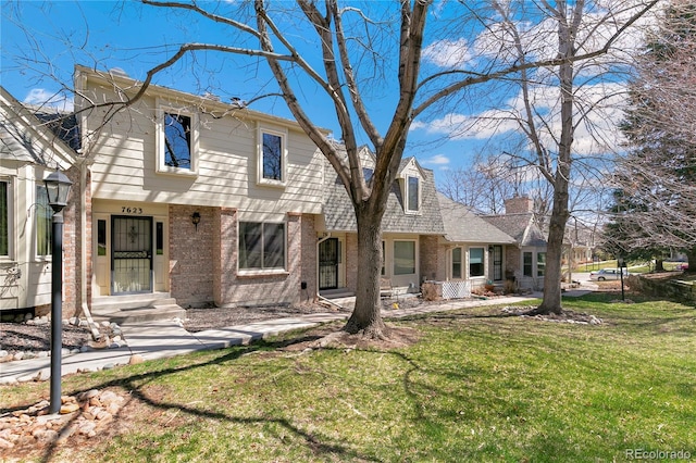 rear view of house featuring a yard