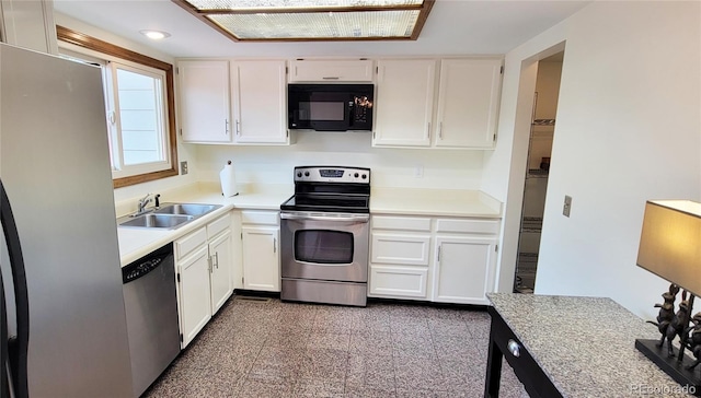 kitchen with white cabinetry, sink, and appliances with stainless steel finishes