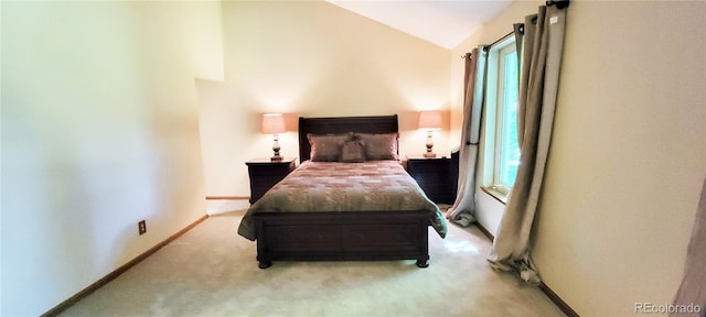 bedroom featuring multiple windows, light carpet, and vaulted ceiling