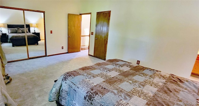 bedroom with light colored carpet and a closet