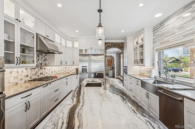 kitchen featuring under cabinet range hood, recessed lighting, appliances with stainless steel finishes, and a sink