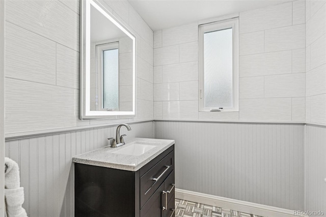 bathroom featuring vanity and a wainscoted wall