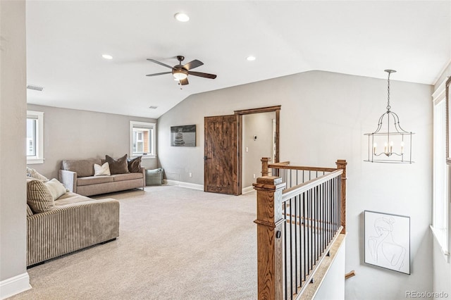 living area with plenty of natural light, recessed lighting, ceiling fan with notable chandelier, and vaulted ceiling
