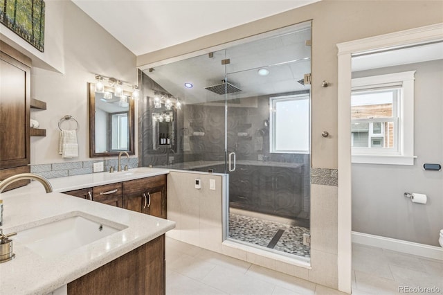 full bathroom featuring vanity, baseboards, tile patterned floors, and a shower stall