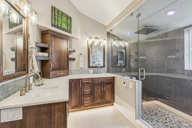full bath with double vanity, vaulted ceiling, a stall shower, a sink, and recessed lighting