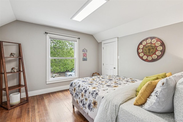 bedroom with baseboards, dark wood finished floors, and lofted ceiling