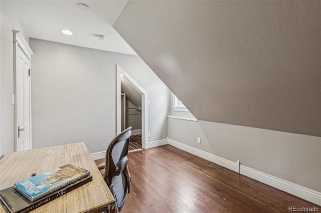 office space with baseboards, recessed lighting, lofted ceiling, and hardwood / wood-style floors