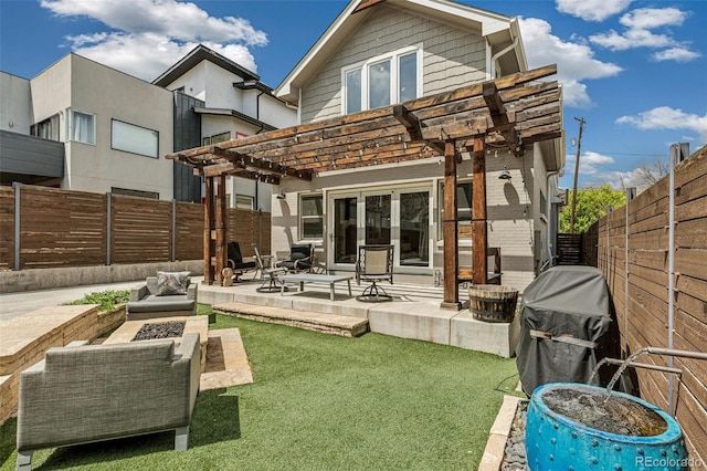 rear view of house featuring a pergola, an outdoor fire pit, a fenced backyard, a patio area, and a lawn