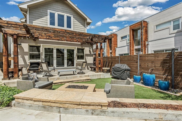 back of house featuring fence, a pergola, brick siding, a patio area, and an outdoor fire pit
