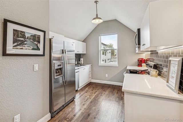 kitchen with appliances with stainless steel finishes, white cabinets, backsplash, and dark wood-type flooring