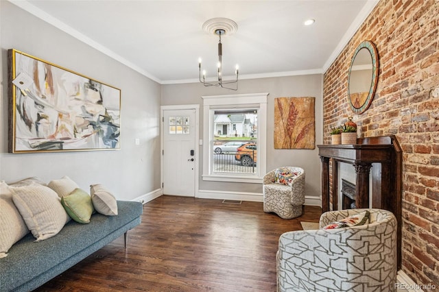 entryway with ornamental molding, wood finished floors, brick wall, baseboards, and a chandelier