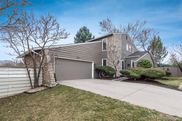 view of front of property with a garage, concrete driveway, and a front yard