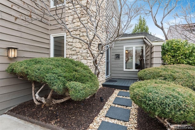 property entrance with stone siding