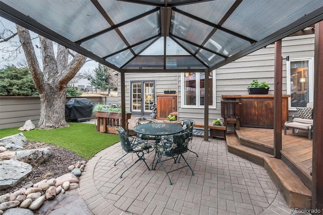 view of patio / terrace with grilling area, fence, a gazebo, a deck, and outdoor dining space