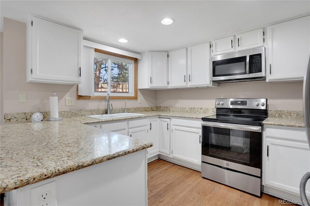 5603 S Pagosa Ct, Centennial, CO 80015 - kitchen featuring a sink, white cabinets, stainless steel appliances, and recessed lighting