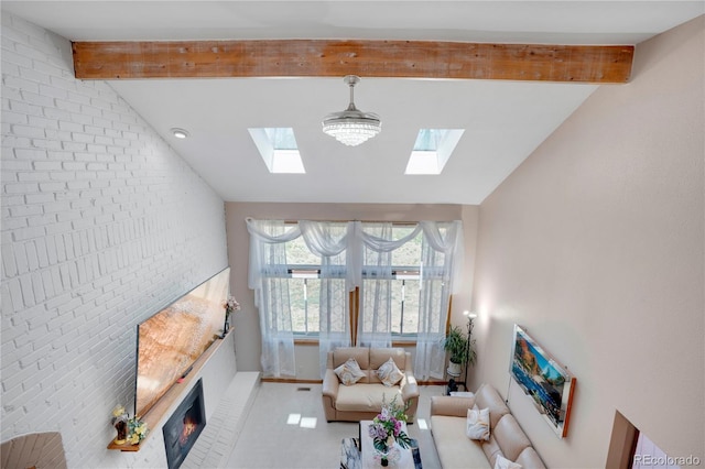 5603 S Pagosa Ct, Centennial, CO 80015 - living area featuring baseboards, a glass covered fireplace, vaulted ceiling with skylight, and brick wall