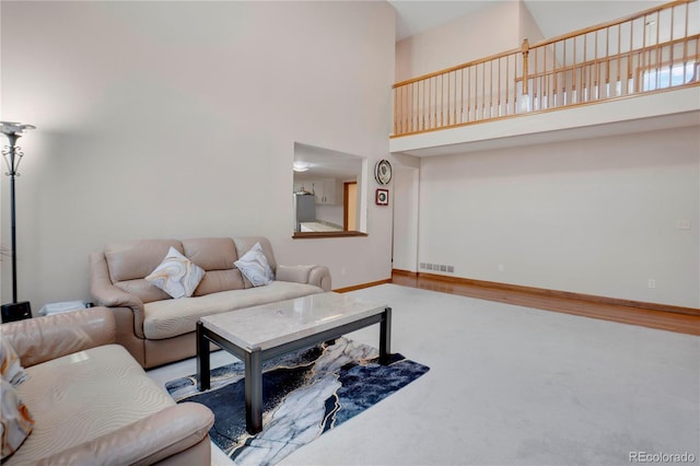 5603 S Pagosa Ct, Centennial, CO 80015 - carpeted living area featuring baseboards, a high ceiling, and visible vents