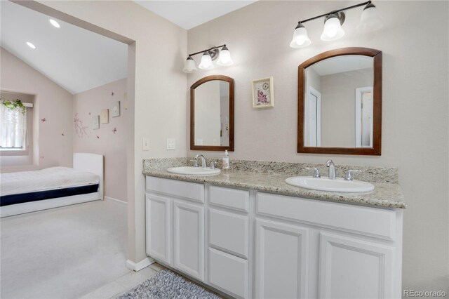 5603 S Pagosa Ct, Centennial, CO 80015 - bathroom featuring a sink, tile patterned floors, double vanity, and lofted ceiling
