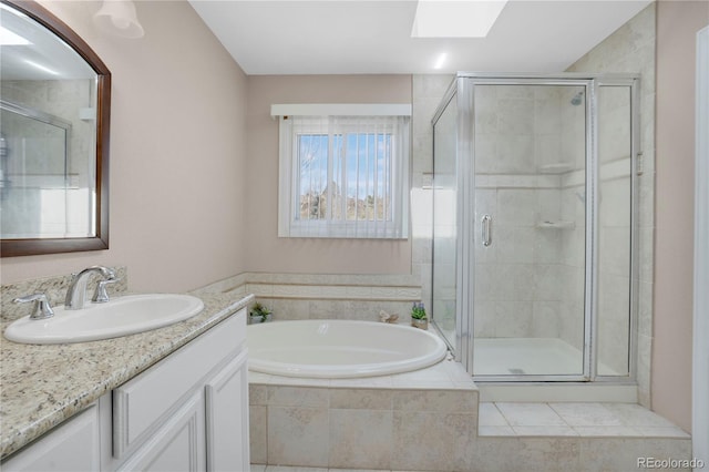 5603 S Pagosa Ct, Centennial, CO 80015 - full bathroom featuring vanity, a skylight, a bath, and a stall shower