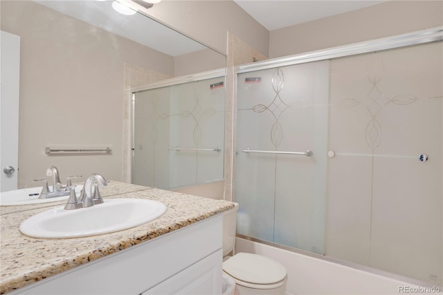 5603 S Pagosa Ct, Centennial, CO 80015 - full bath featuring toilet, bath / shower combo with glass door, and vanity