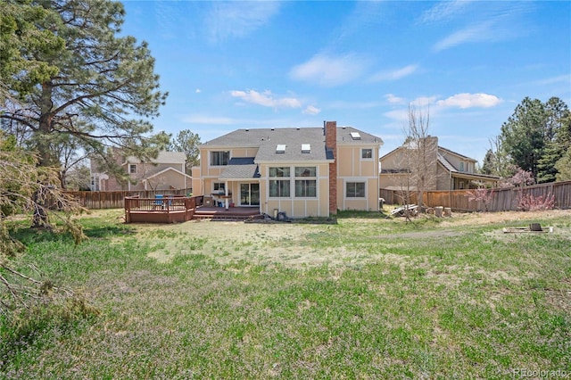 5603 S Pagosa Ct, Centennial, CO 80015 - back of property featuring a lawn, a fenced backyard, and a deck