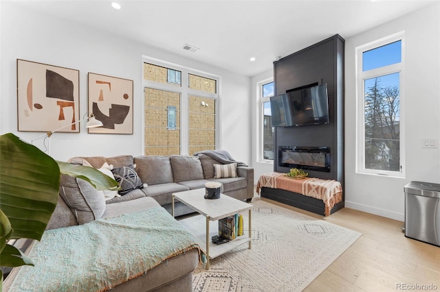 1232 N Yates St Unit 3, Denver, CO 80204 - living room featuring recessed lighting, plenty of natural light, and wood finished floors