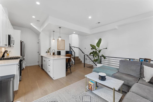 1232 N Yates St Unit 3, Denver, CO 80204 - living room featuring light wood-style floors, stairway, and recessed lighting
