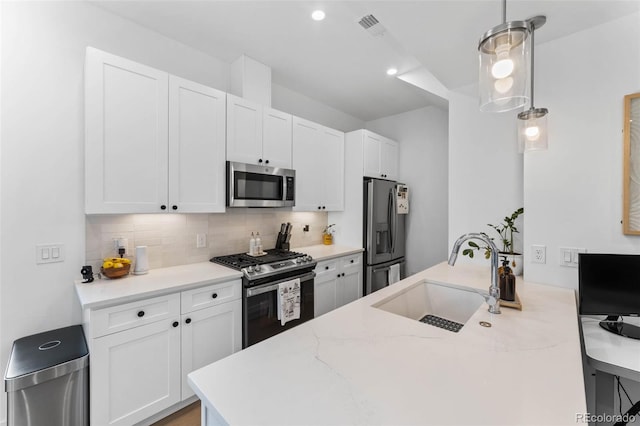 1232 N Yates St Unit 3, Denver, CO 80204 - kitchen with appliances with stainless steel finishes, backsplash, white cabinets, decorative light fixtures, and light stone counters