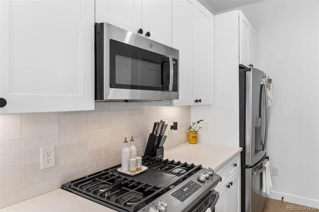 1232 N Yates St Unit 3, Denver, CO 80204 - kitchen featuring stainless steel appliances, white cabinetry, decorative backsplash, and light countertops