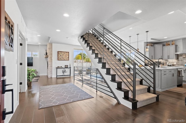 foyer entrance featuring stairway, recessed lighting, and dark wood-style flooring