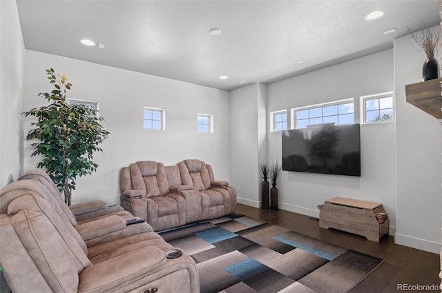 living room featuring recessed lighting, baseboards, and wood finished floors