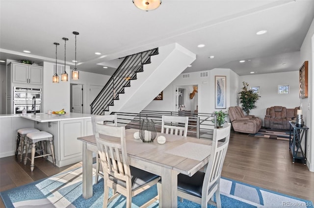 dining space with recessed lighting, wood finished floors, and visible vents