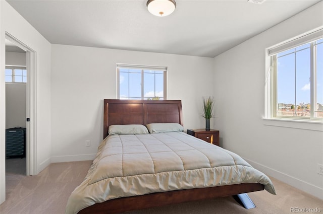 carpeted bedroom featuring baseboards