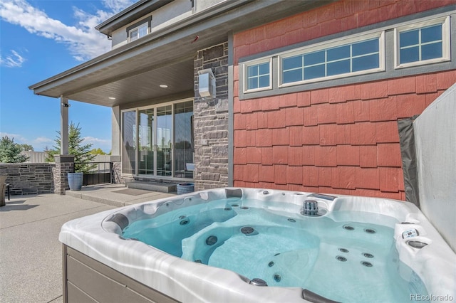 view of patio / terrace with a hot tub