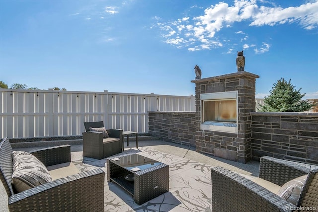 view of patio featuring an outdoor living space and fence